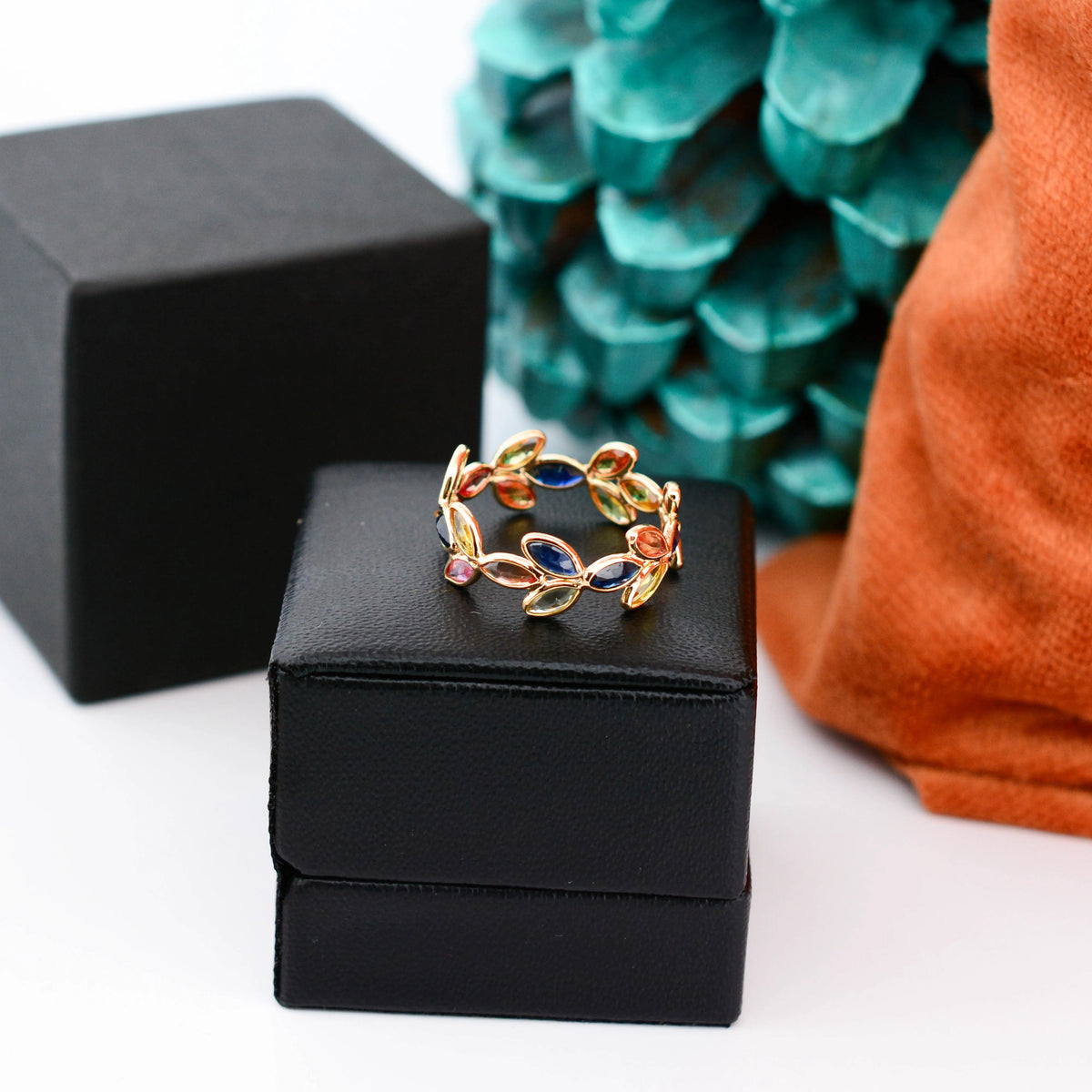 18K gold ring with marquise-cut rainbow sapphires in a leaf and vine motif