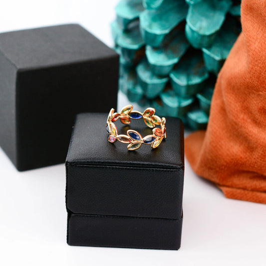 18K gold ring with marquise-cut rainbow sapphires in a leaf and vine motif
