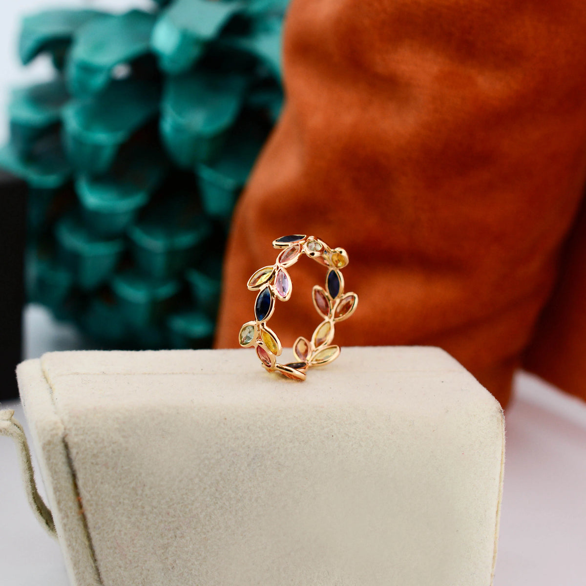18K gold ring with marquise-cut rainbow sapphires in a leaf and vine motif