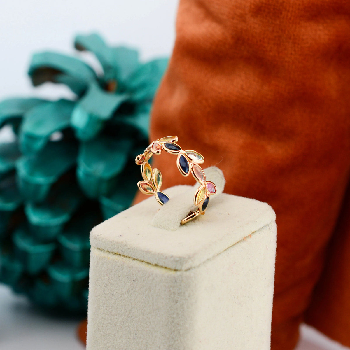 18K gold ring with marquise-cut rainbow sapphires in a leaf and vine motif