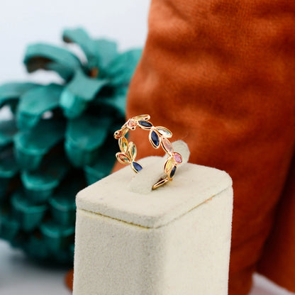 18K gold ring with marquise-cut rainbow sapphires in a leaf and vine motif