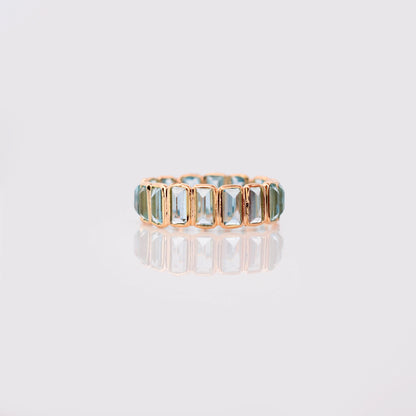 18K gold eternity ring with baguette-cut Swiss blue topaz stones