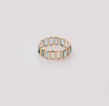 18K gold eternity ring with baguette-cut Swiss blue topaz stones
