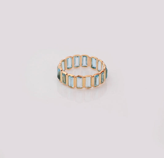 18K gold eternity ring with baguette-cut Swiss blue topaz stones