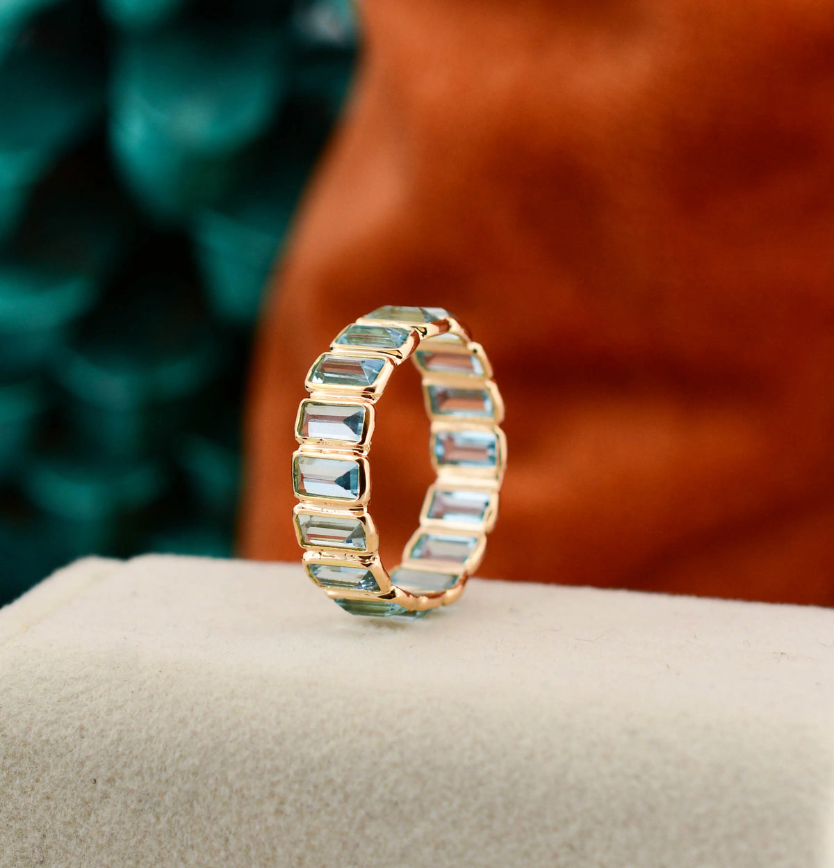 18K gold eternity ring with baguette-cut Swiss blue topaz stones
