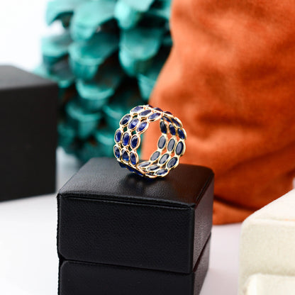 18K gold wide cocktail ring with three rows of bezel-set blue sapphires