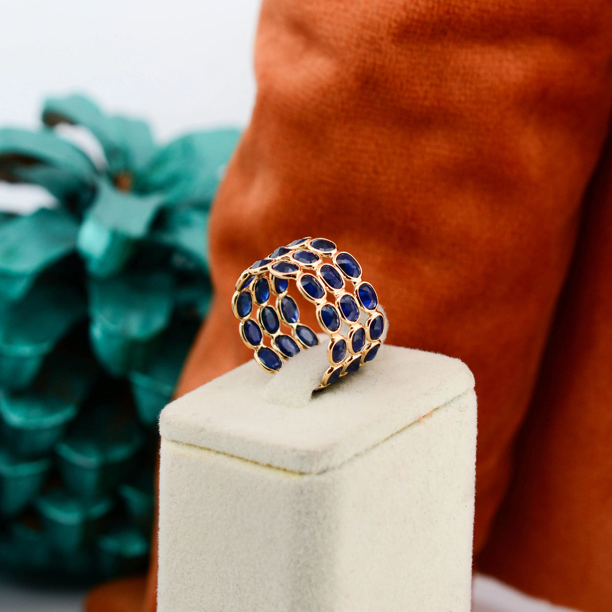18K gold wide cocktail ring with three rows of bezel-set blue sapphires
