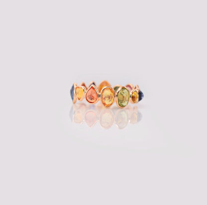 18K gold eternity ring with mixed-cut rainbow sapphire stones
