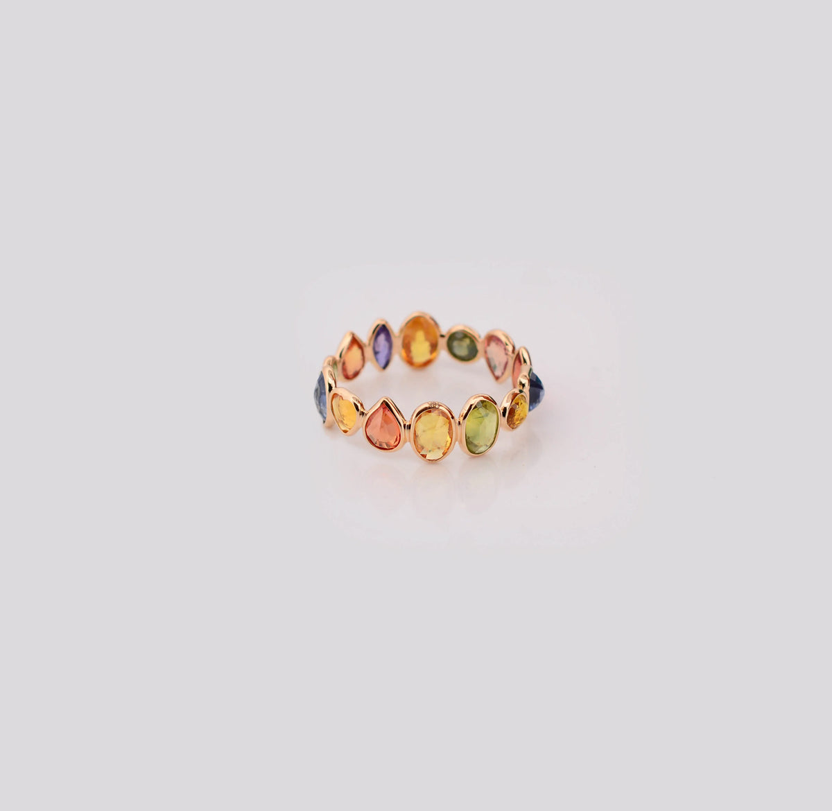 18K gold eternity ring with mixed-cut rainbow sapphire stones