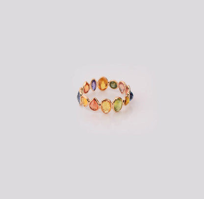 18K gold eternity ring with mixed-cut rainbow sapphire stones