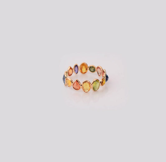 18K gold eternity ring with mixed-cut rainbow sapphire stones