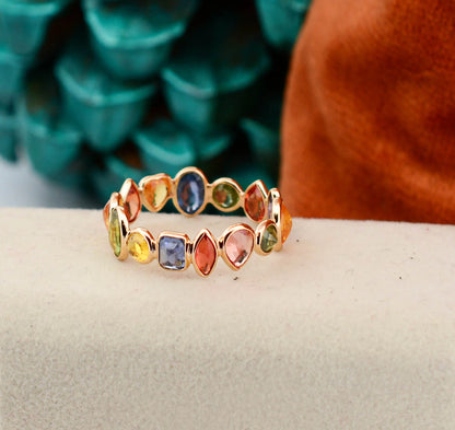 18K gold eternity ring with mixed-cut rainbow sapphire stones