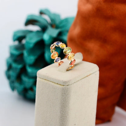 18K gold eternity ring with mixed-cut rainbow sapphire stones