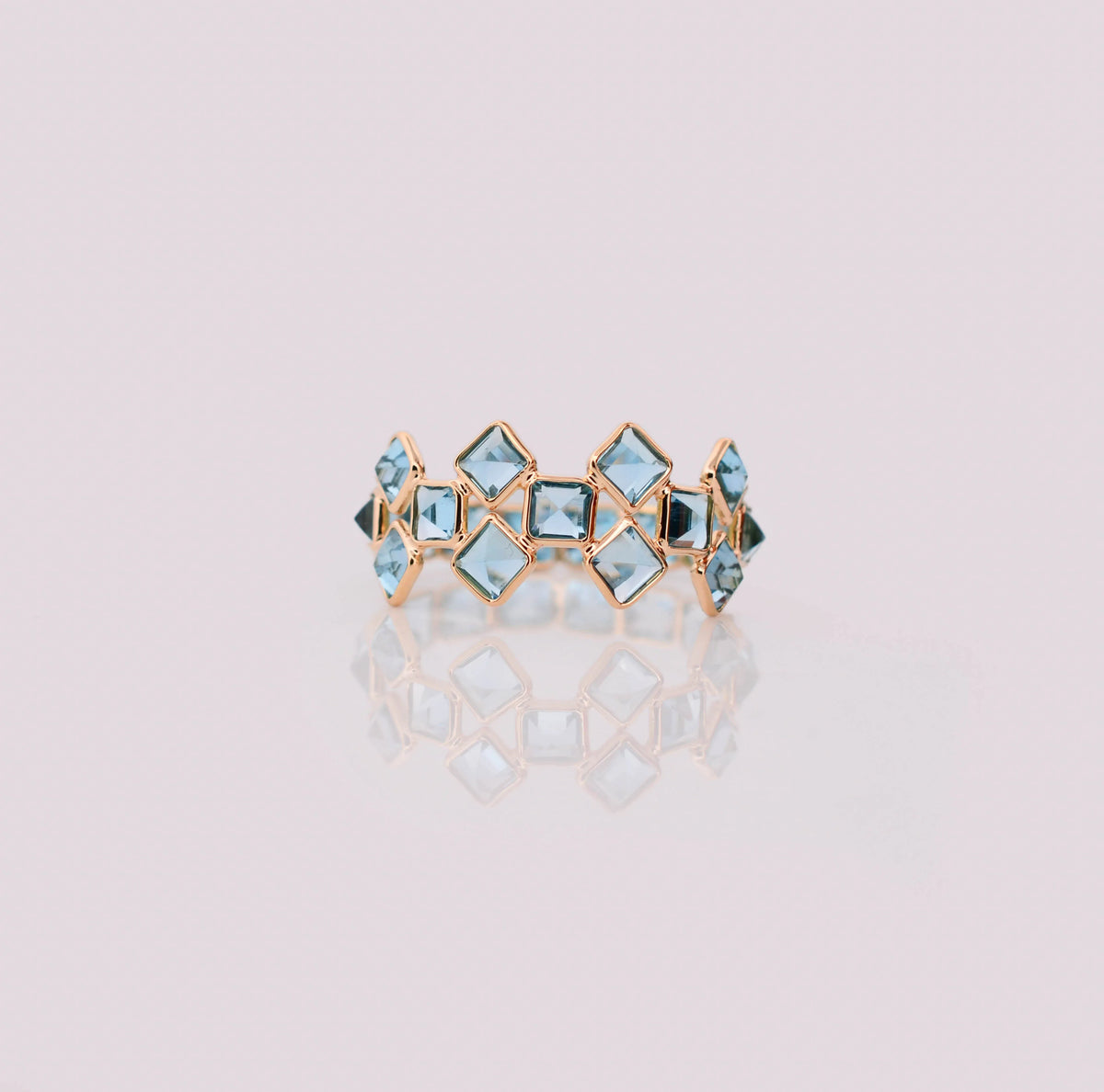 18K gold eternity ring with Swiss blue topaz in a mosaic checkerboard pattern