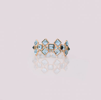 18K gold eternity ring with Swiss blue topaz in a mosaic checkerboard pattern