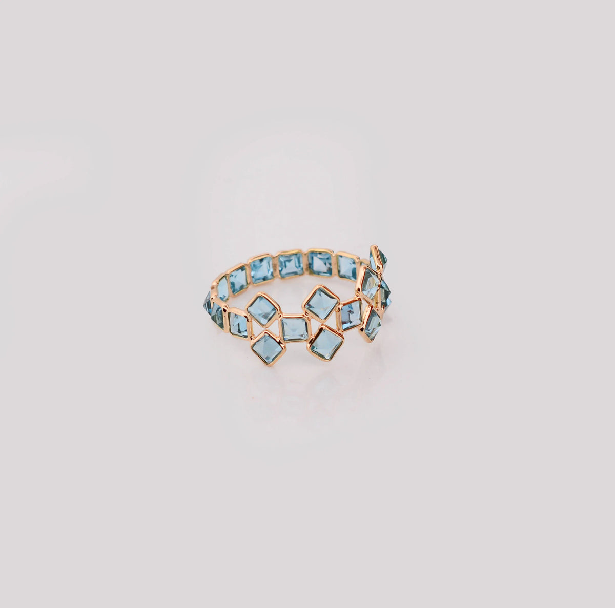 18K gold eternity ring with Swiss blue topaz in a mosaic checkerboard pattern
