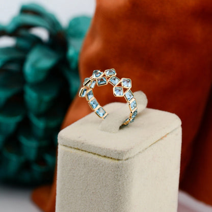18K gold eternity ring with Swiss blue topaz in a mosaic checkerboard pattern