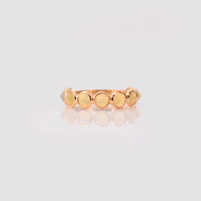18K gold eternity ring with bezel-set opals and diamond accents