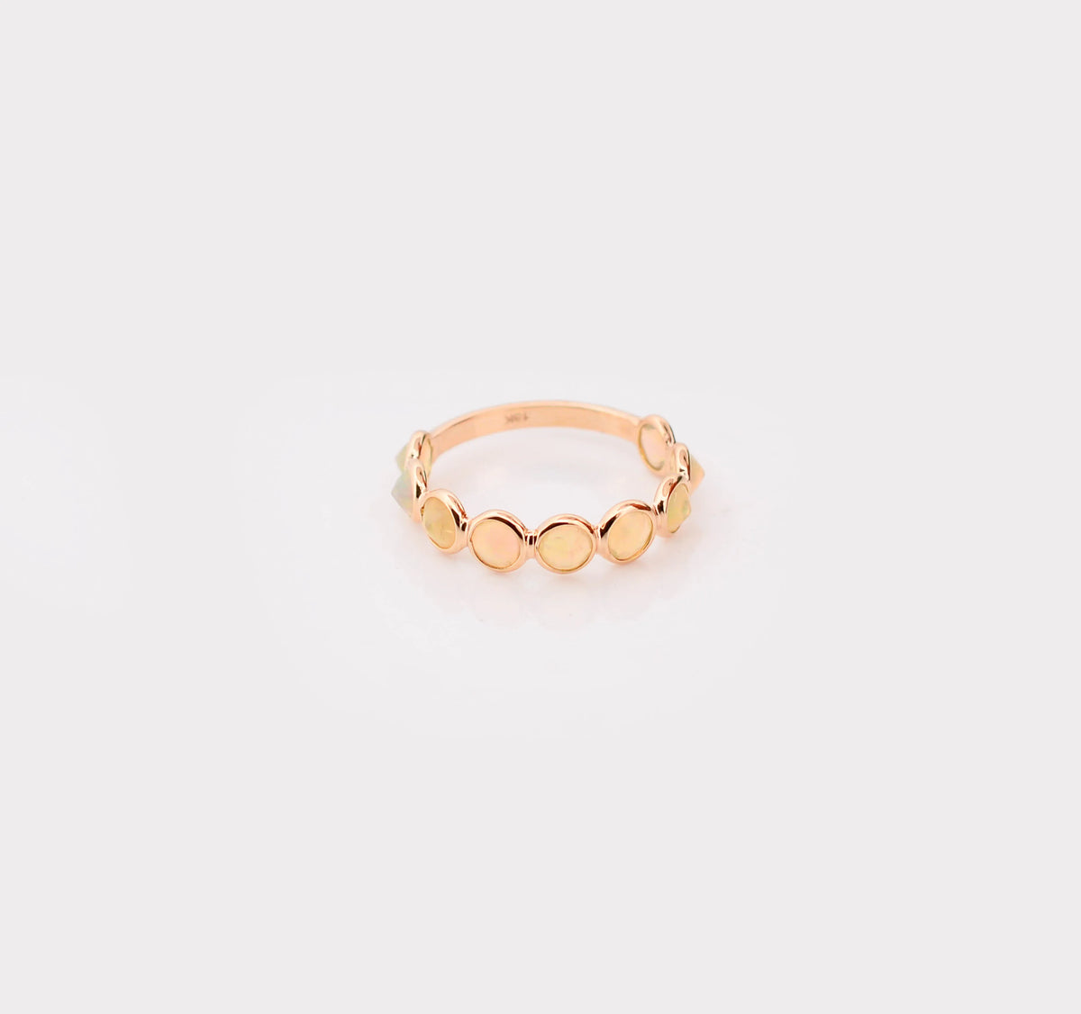 18K gold eternity ring with bezel-set opals and diamond accents