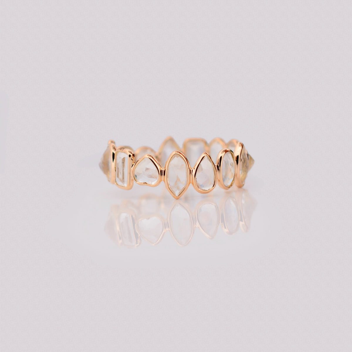 18K gold eternity ring with mixed-cut rainbow moonstone stones
