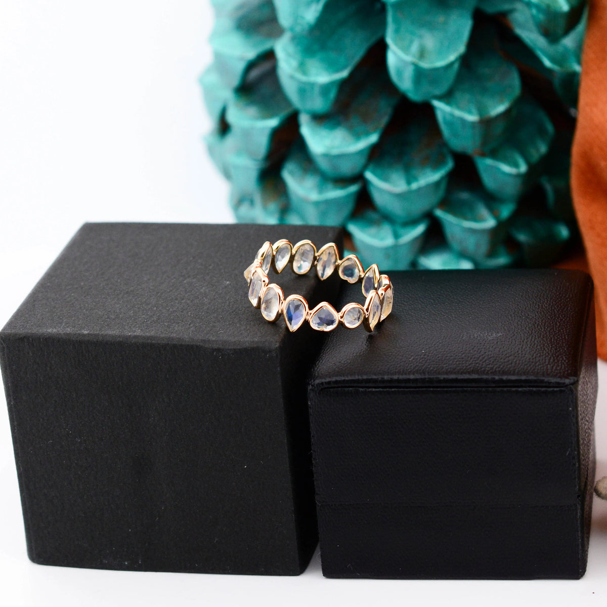 18K gold eternity ring with mixed-cut rainbow moonstone stones