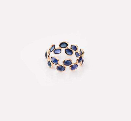 18K gold eternity ring with bezel-set oval-cut blue sapphires