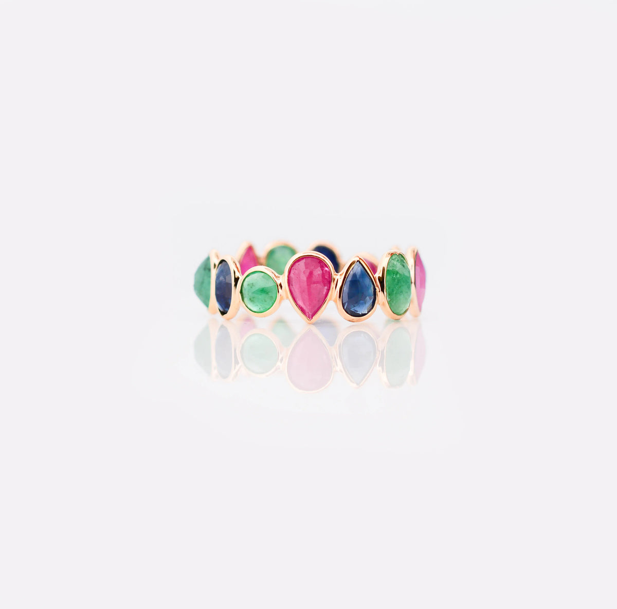 18K gold eternity ring with mixed sapphire, emerald, and ruby gemstones