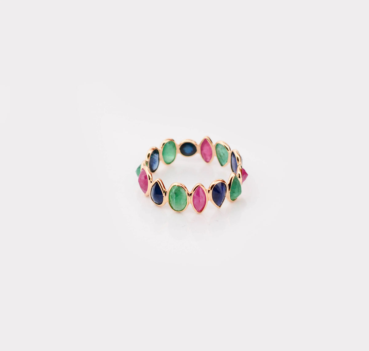 18K gold eternity ring with mixed sapphire, emerald, and ruby gemstones