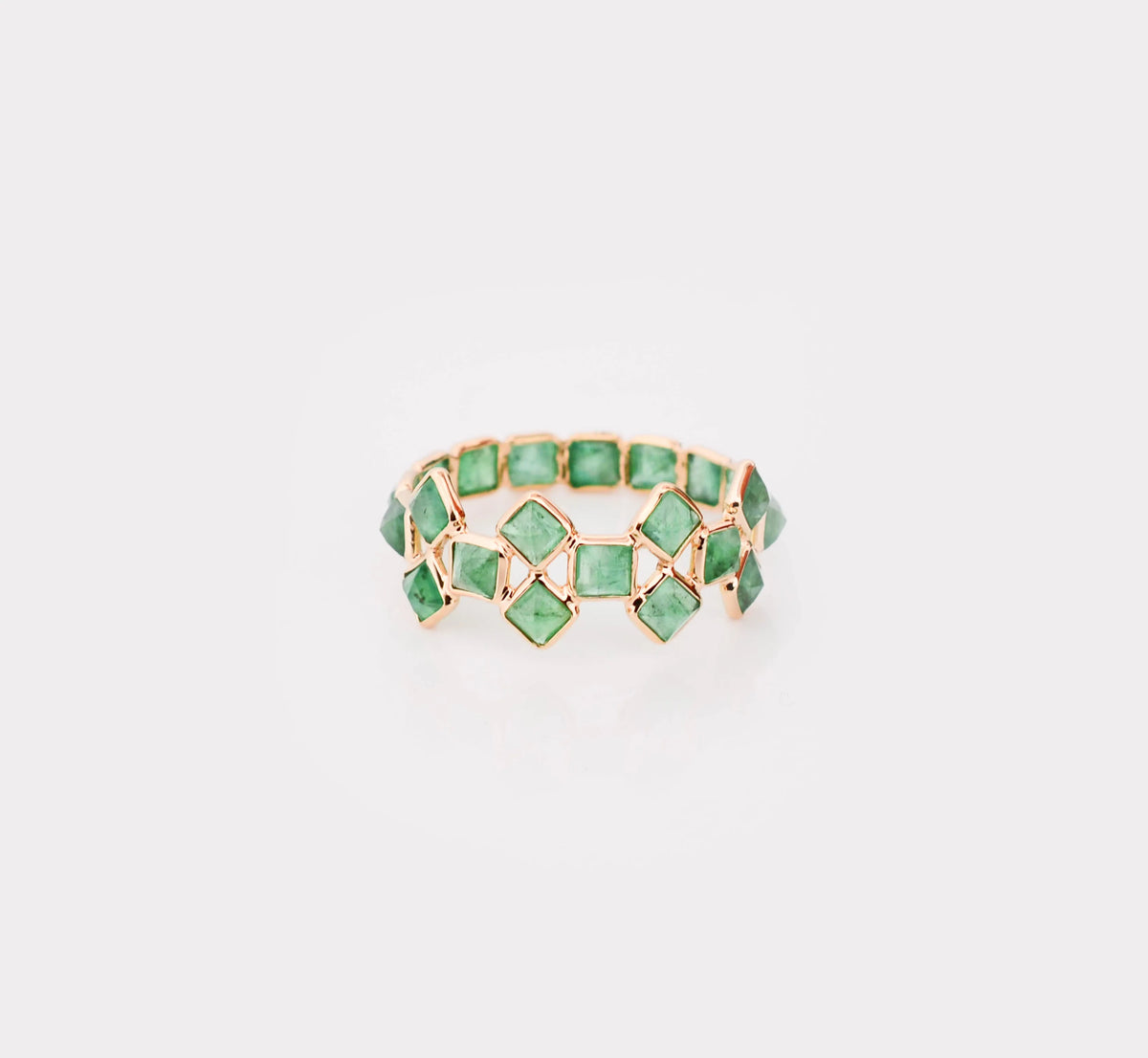 18K gold eternity ring with square-cut emeralds in a checkerboard lattice pattern