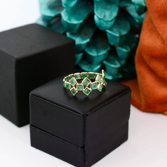 18K gold eternity ring with square-cut emeralds in a checkerboard lattice pattern