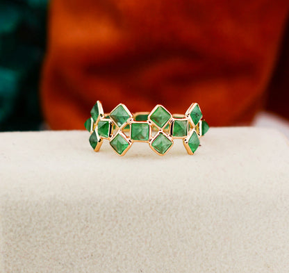 18K gold eternity ring with square-cut emeralds in a checkerboard lattice pattern