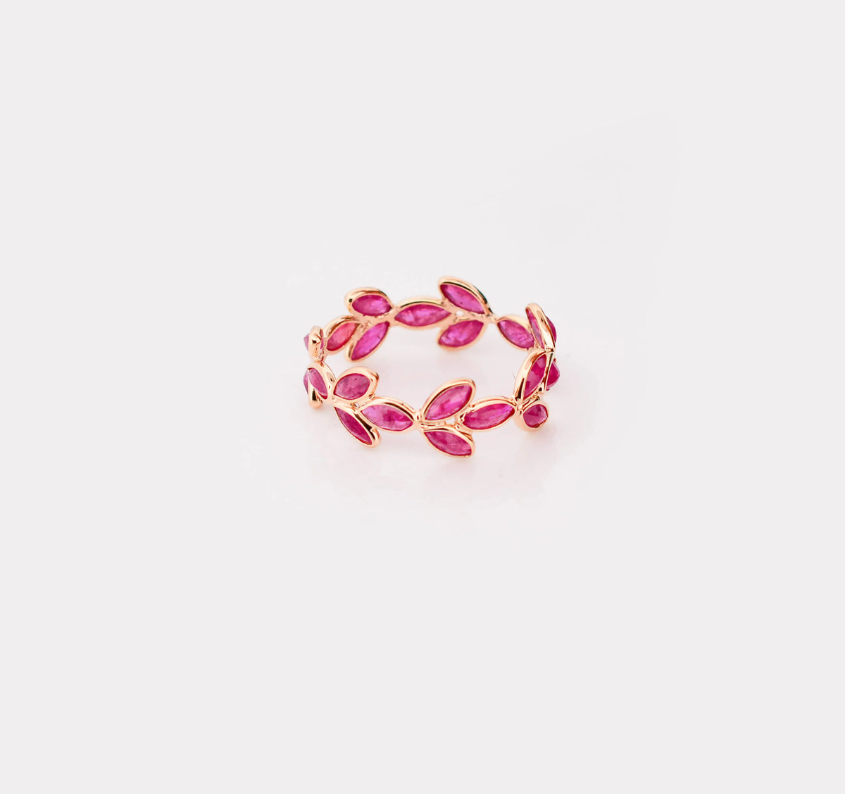 18K gold eternity ring with marquise-cut rubies in a floral vine design