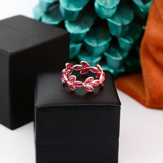 18K gold eternity ring with marquise-cut rubies in a floral vine design