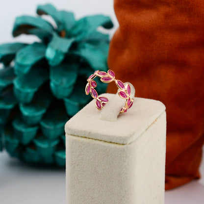 18K gold eternity ring with marquise-cut rubies in a floral vine design