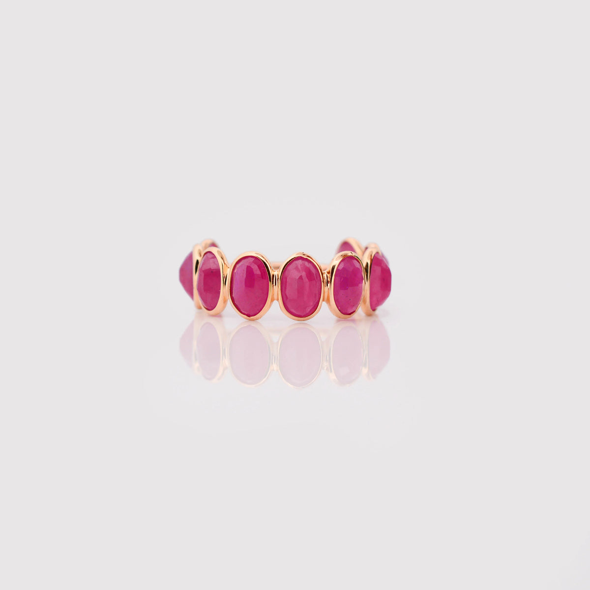 18K gold eternity ring with bezel-set oval-cut rubies
