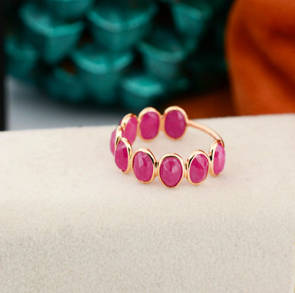18K gold eternity ring with bezel-set oval-cut rubies