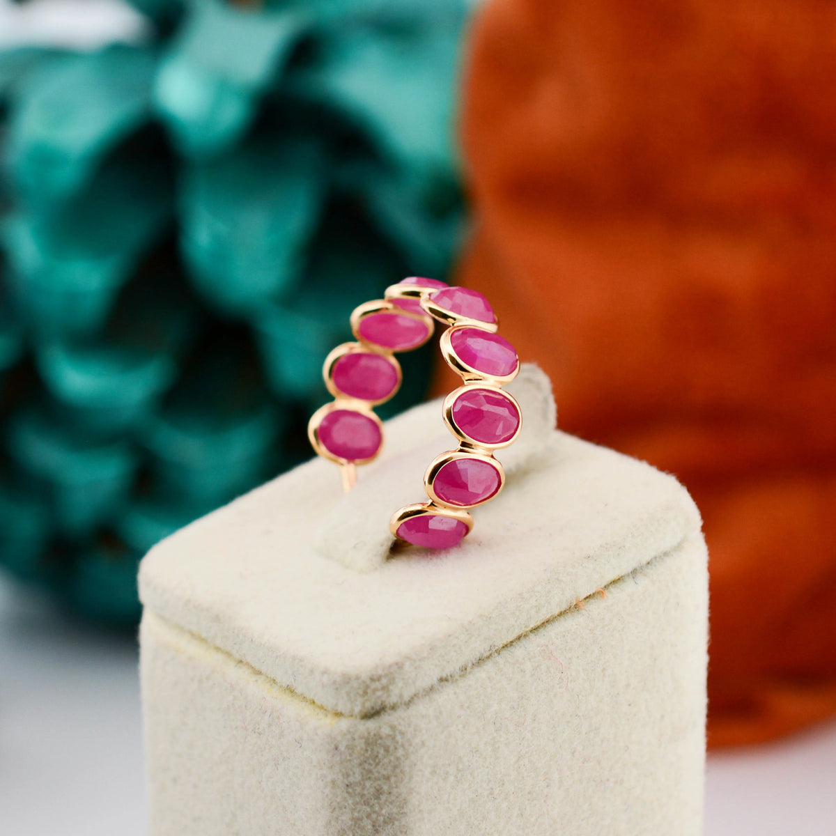 18K gold eternity ring with bezel-set oval-cut rubies